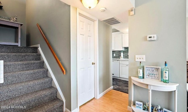 stairway with hardwood / wood-style floors