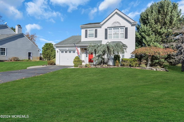 front of property with a front yard and a garage