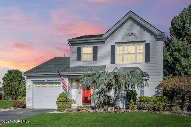 view of front property with a lawn and a garage