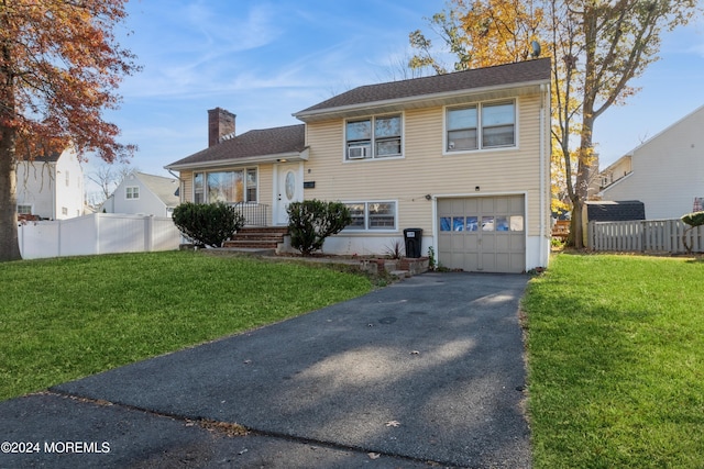 split level home with a front lawn and a garage