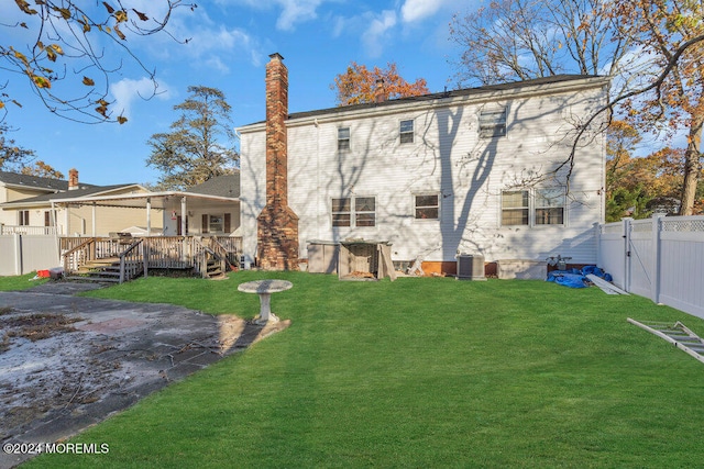 back of house with a yard, a patio area, a deck, and central AC unit