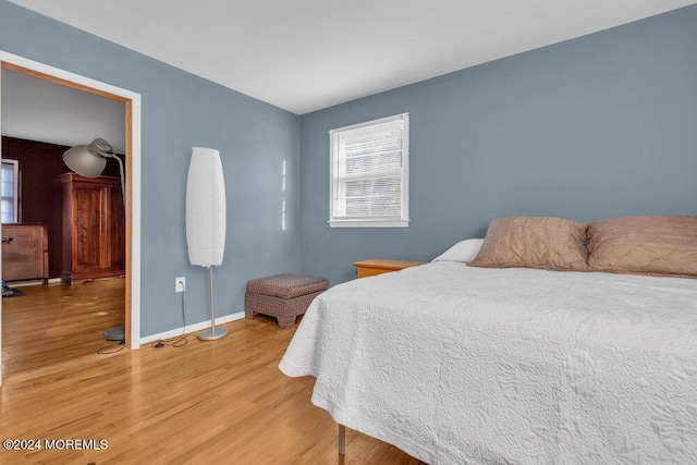 bedroom with hardwood / wood-style floors