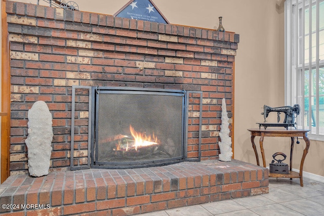 room details featuring a fireplace and tile patterned flooring