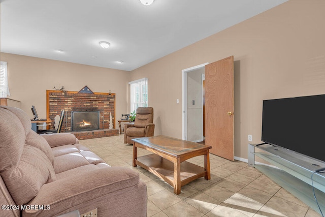 tiled living room featuring a brick fireplace