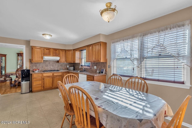 kitchen featuring tasteful backsplash, sink, white dishwasher, gas cooktop, and light hardwood / wood-style flooring