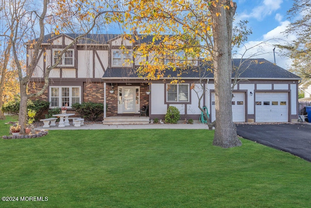 view of front of house featuring a garage and a front lawn