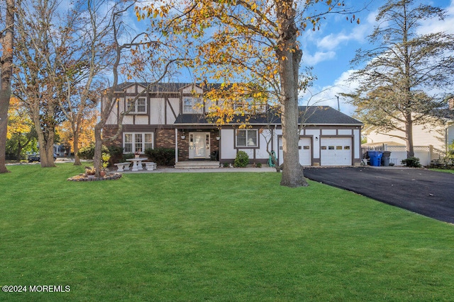 view of front facade with a porch, a front yard, and a garage