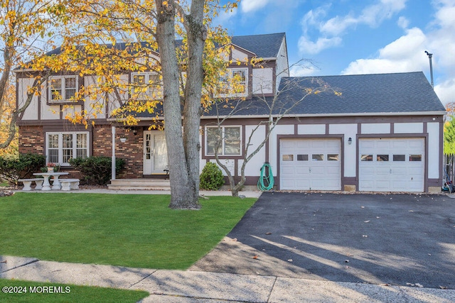 view of front facade featuring french doors, a front yard, and a garage