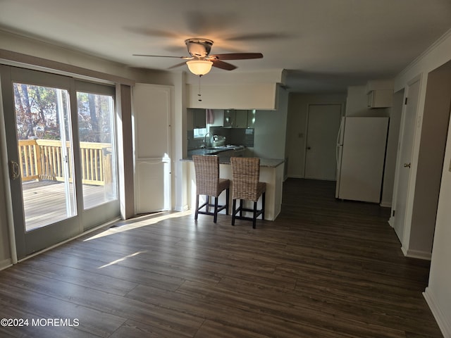 813 Beechmont St, Toms River, NJ 08757 - kitchen featuring freestanding refrigerator, a ceiling fan, a breakfast bar, dark wood-style flooring, and a peninsula