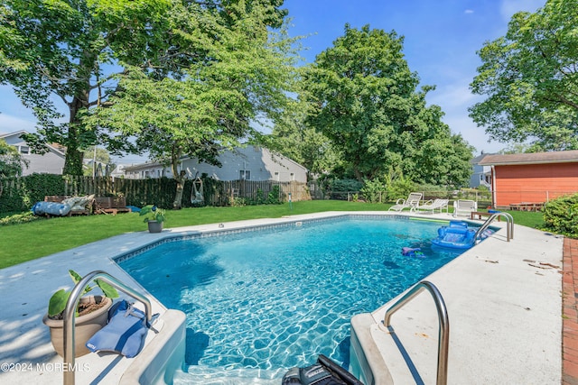 view of pool featuring a patio and a lawn