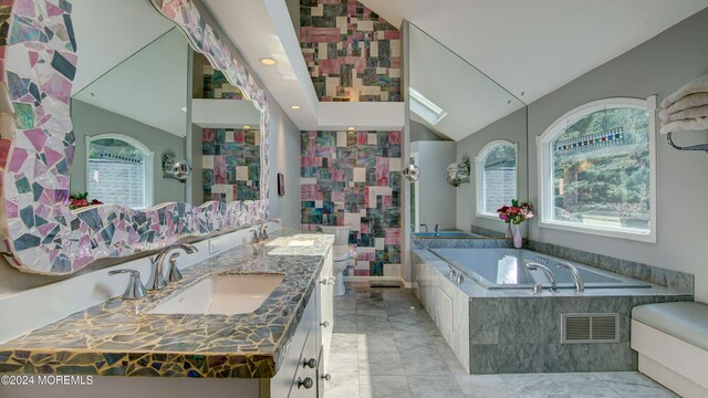 bathroom with tiled bath, toilet, a wealth of natural light, and lofted ceiling