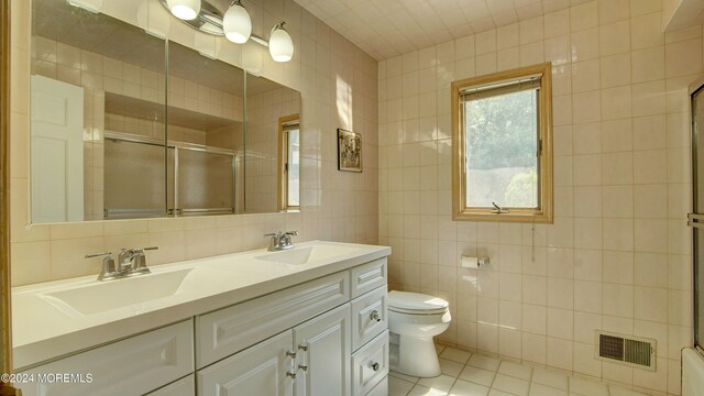 bathroom with tile patterned floors, backsplash, toilet, and tile walls