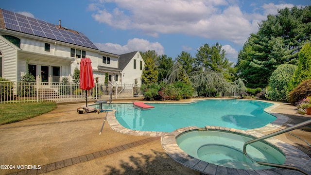 view of pool featuring a patio area and an in ground hot tub