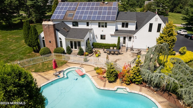 exterior space featuring solar panels, a patio, and a fenced in pool