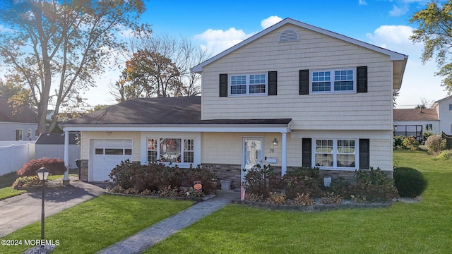 view of front of home featuring a garage and a front lawn