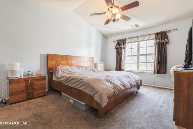 carpeted bedroom with ceiling fan and vaulted ceiling