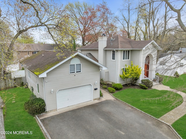 view of front of house featuring a front yard and a garage