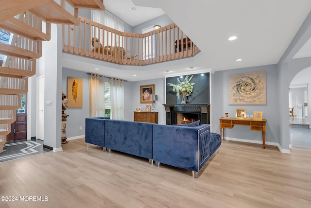 living room featuring hardwood / wood-style flooring and a high ceiling