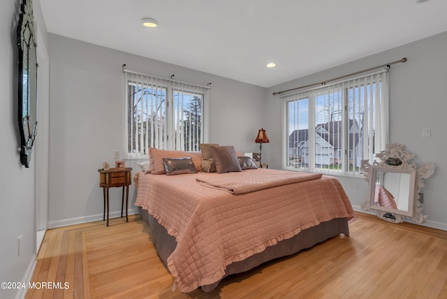 bedroom featuring multiple windows and light wood-type flooring