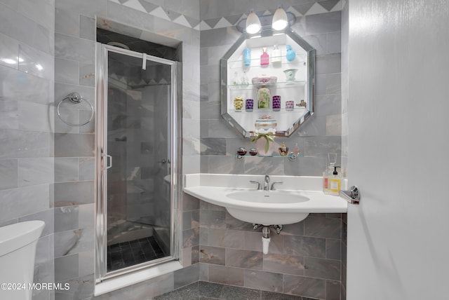 bathroom featuring toilet, walk in shower, and tile walls