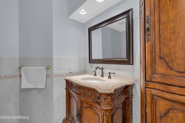 bathroom featuring tile walls and vanity