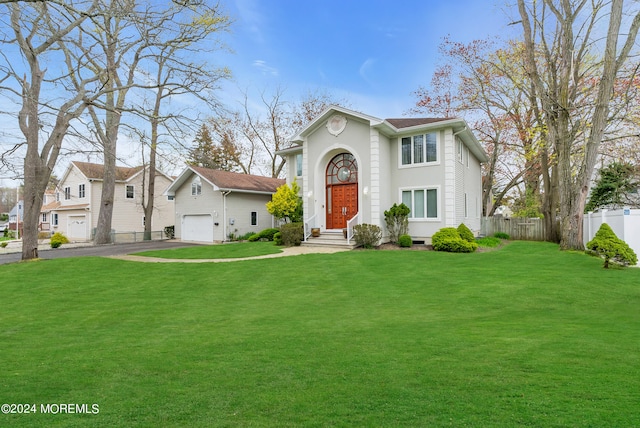 view of front of property featuring a front yard and a garage