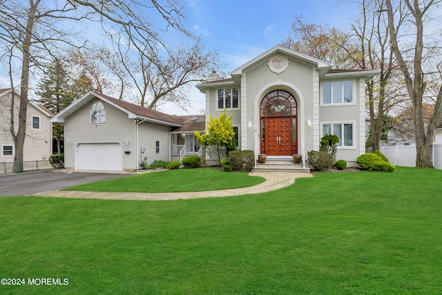 view of front facade featuring a front yard and a garage