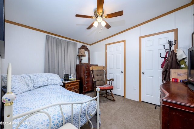 carpeted bedroom featuring lofted ceiling, ornamental molding, and ceiling fan