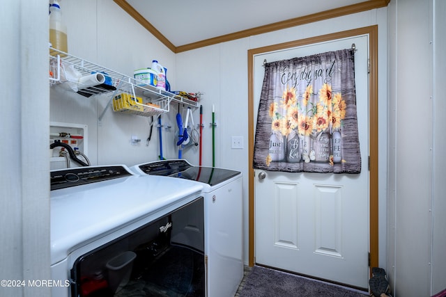 clothes washing area with dark carpet, ornamental molding, and washing machine and dryer