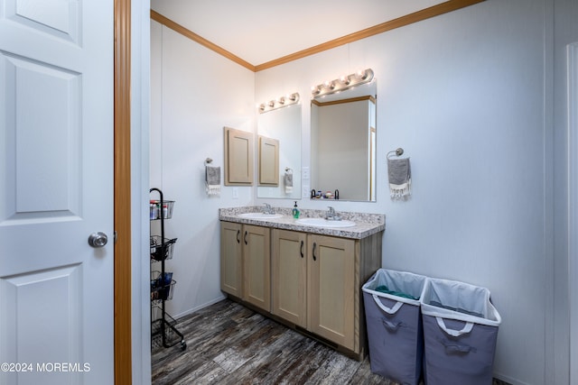 bathroom with vanity, crown molding, and hardwood / wood-style floors