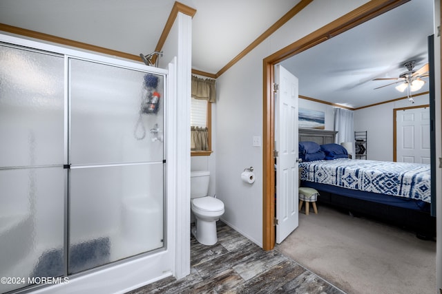 bathroom with toilet, an enclosed shower, ceiling fan, and crown molding