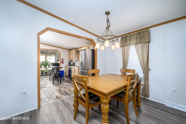 dining area with crown molding, vaulted ceiling, a notable chandelier, and dark hardwood / wood-style flooring