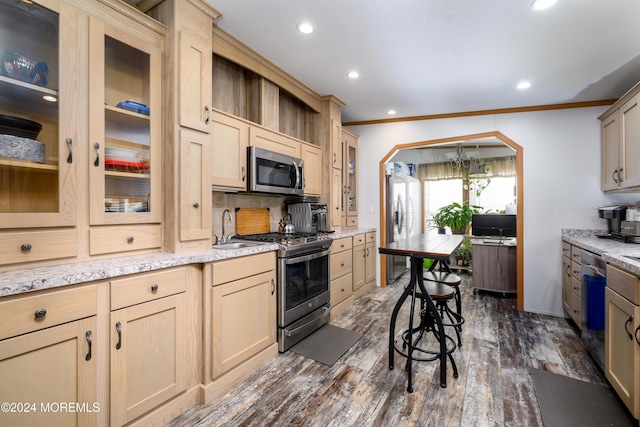 kitchen featuring stainless steel appliances, glass insert cabinets, dark wood finished floors, crown molding, and recessed lighting