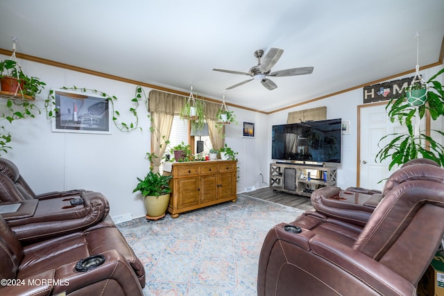 living room with a ceiling fan, crown molding, baseboards, and wood finished floors