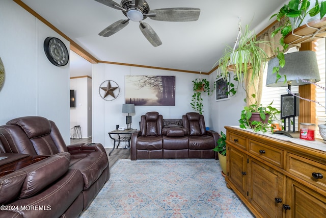 living area featuring crown molding, ceiling fan, and vaulted ceiling
