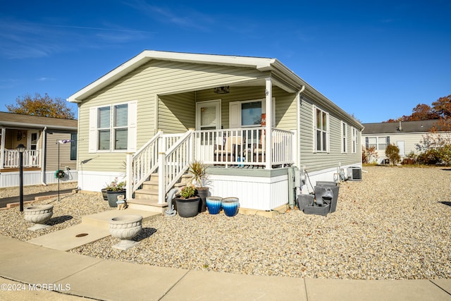 manufactured / mobile home with central air condition unit and covered porch