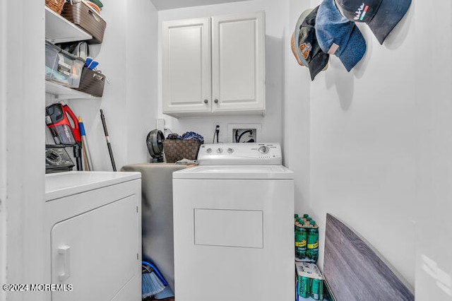 laundry room featuring cabinets and separate washer and dryer