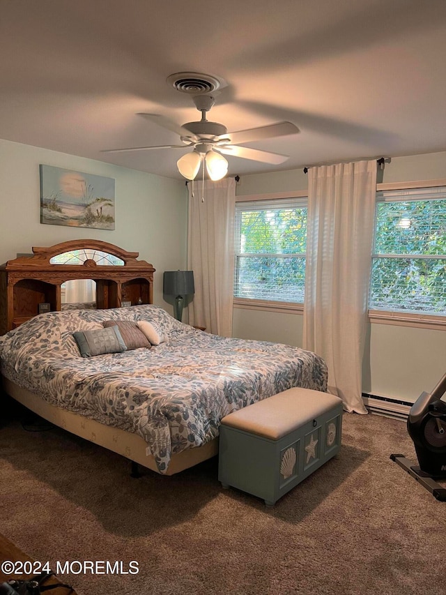 carpeted bedroom with a baseboard radiator and ceiling fan