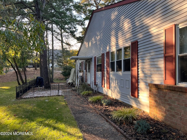 view of property exterior featuring a lawn