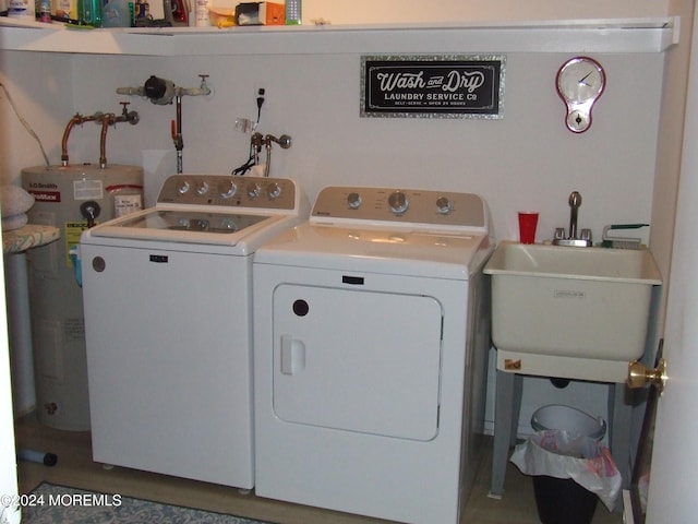 washroom with washing machine and dryer, sink, and water heater