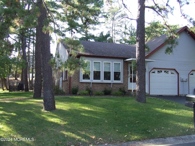 view of front of home with a garage and a front lawn