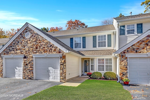 front facade with a front yard and a garage