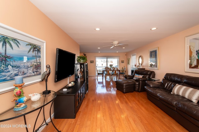 living room featuring ceiling fan and light wood-type flooring