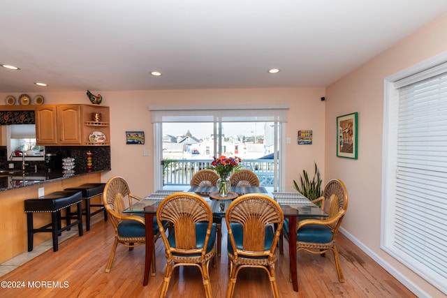 dining room with light hardwood / wood-style floors and sink