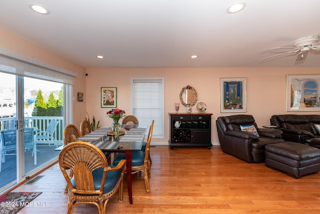 dining area with light hardwood / wood-style flooring and ceiling fan