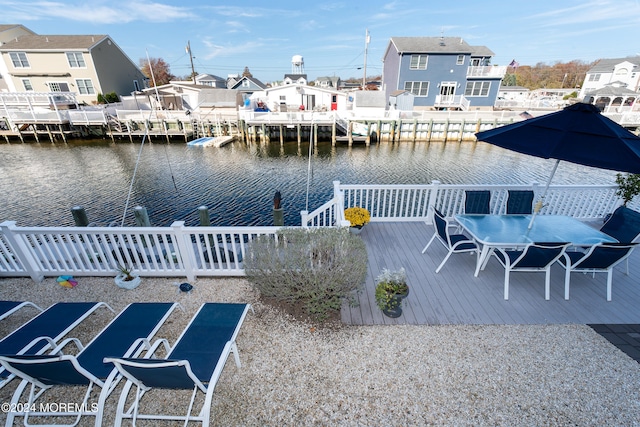 view of dock with a deck with water view