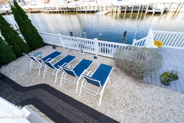 view of patio featuring a boat dock and a water view