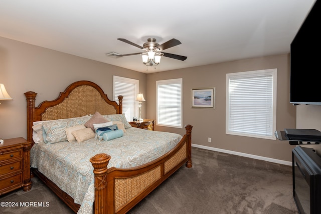 bedroom with dark colored carpet and ceiling fan