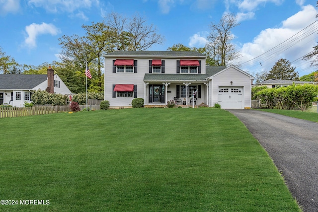 view of front facade with a front lawn, a garage, and covered porch