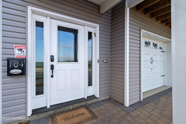 view of exterior entry with a garage